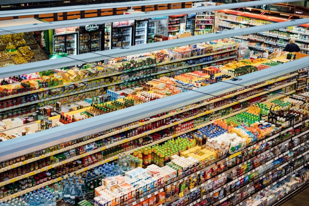 Supermarket aisle with shelves stocked with FMCG products and packaged goods